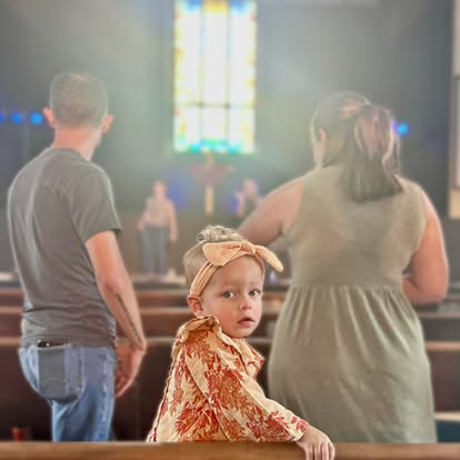 A young child with family during worship at Christ Fellowship Tampa