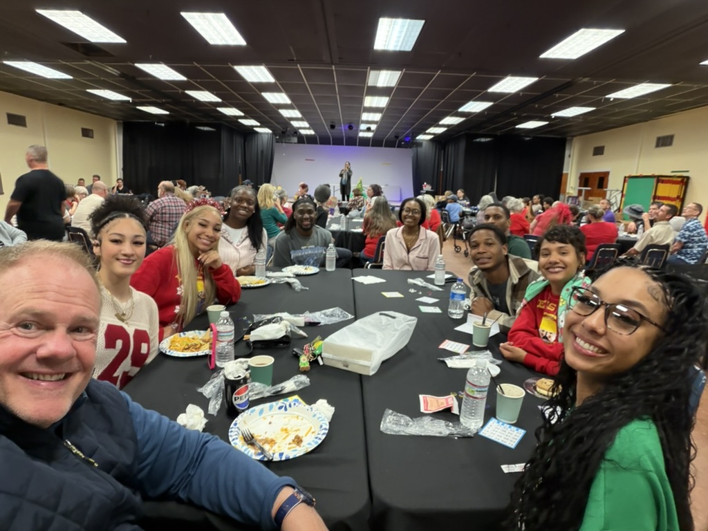 Christ Fellowship friends smiling together around a table